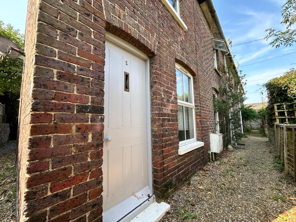 Lot: 65 - TWO-BEDROOM COTTAGE FOR INVESTMENT OR OCCUPATION - Cottage with white wooden door
